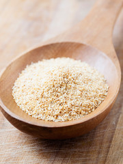 Minced garlic on a wooden spoon