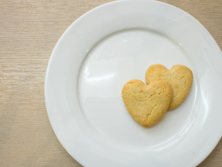 Heart cookies on white plate .Space for text