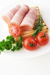Slices of ham with rosemary