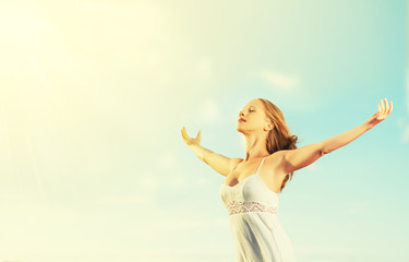 Fototapeta na wymiar happy young woman open her arms to the sky
