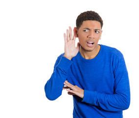 Young man trying to secretly listen in on conversation
