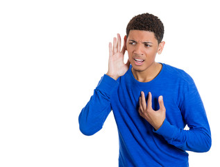 Young man trying to secretly listen in on conversation