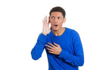 Young man trying to secretly listen in on conversation