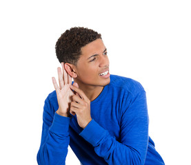 Young man trying to secretly listen in on conversation