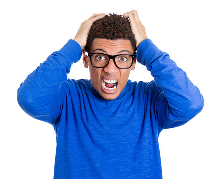 Mad, angry nerdy young man in glasses, screaming