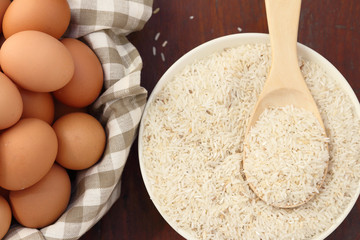Raw rice with spoon and egg