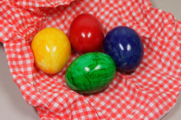 Fototapeta na wymiar colorful eggs on a red and white napkin