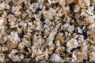 Smoked sea salt flakes, scattered to make background or texture.