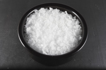 Sea salt flakes, in bowl .