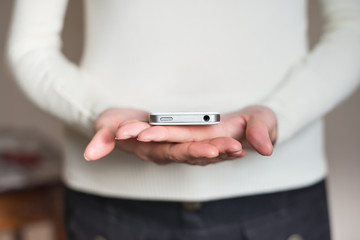 A woman uses a smartphone