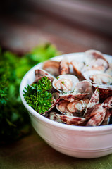 Bowl of Delicious Fresh Steamer Clams with Garlic and Basil on r