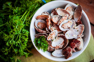 Bowl of Delicious Fresh Steamer Clams with Garlic and Basil on r