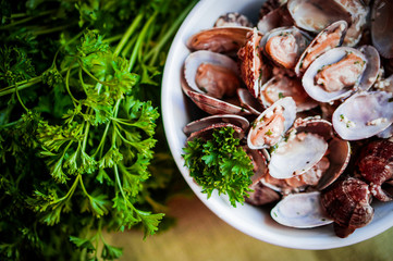 Bowl of Delicious Fresh Steamer Clams with Garlic and Basil on r
