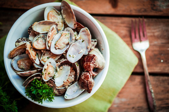 Bowl of Delicious Fresh Steamer Clams with Garlic and Basil on r