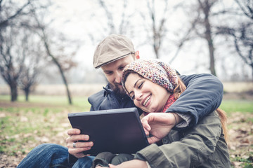 Fototapeta premium couple in love using tablet connecting web wireless wifi