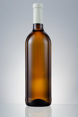 Dark brown glass bottle with white wine isolated