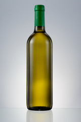 Dark green glass bottle with white wine isolated