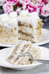 Layer vanilla and chocolate cake. Bouquet of pink carnations in