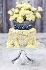White and dark chocolate layer cake decorated with blueberries