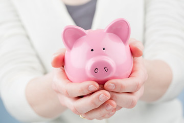 Woman Holding a Piggy Bank