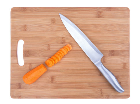 Kitchen board and knife for cutting carrots.