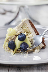 White and dark chocolate layer cake decorated with blueberries