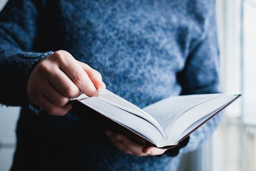 Man reading. Book in his hands.