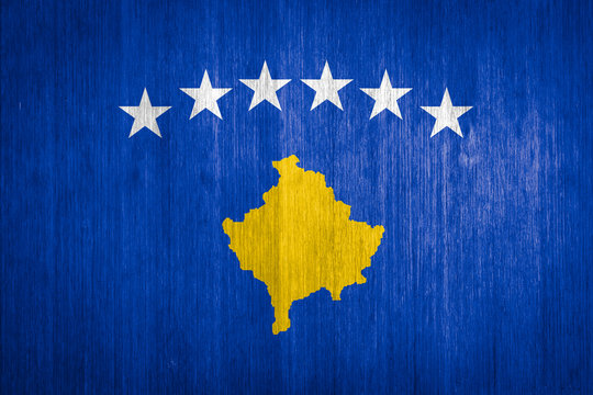 Kosovo Flag on wood background