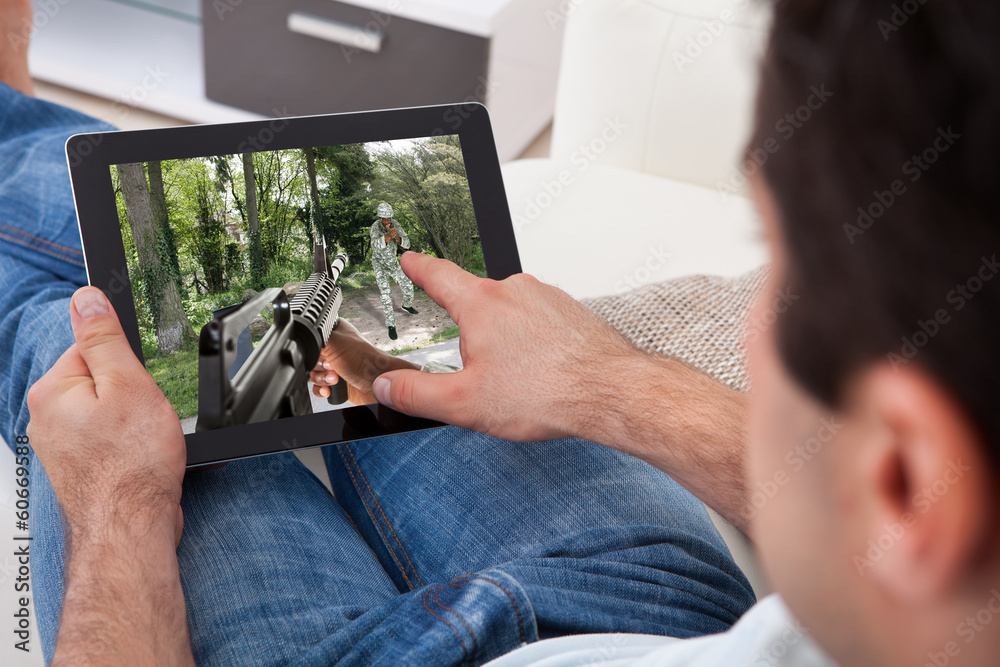 Poster man playing game on tablet pc