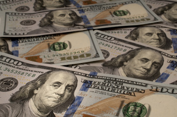 One Hundred Dollar bills with Benjamin Franklin highlighted