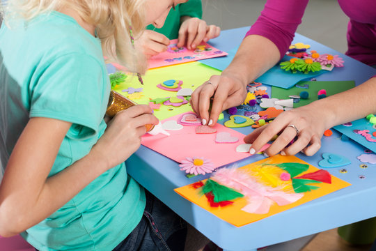 Children making decorations on paper