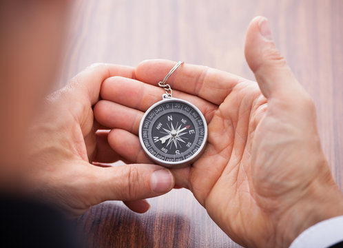 Hand Holding Compass