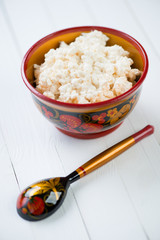 Cottage cheese in russian wooden khokhloma tableware