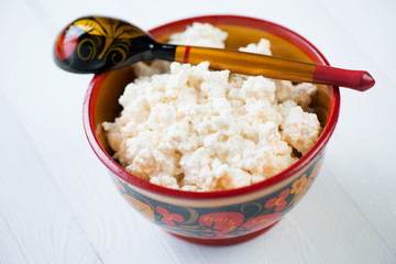 Cottage cheese in russian wooden tableware, horizontal shot