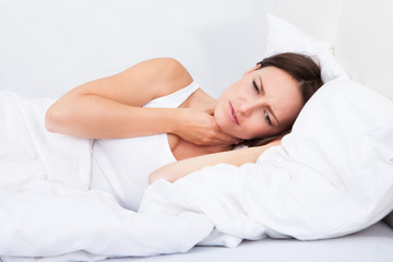 Fototapeta na wymiar Sick Woman Lying In Bed