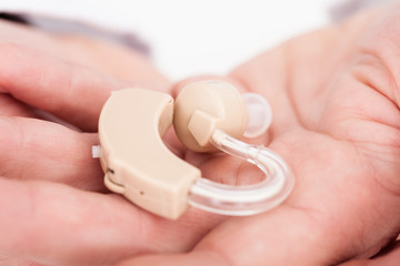 Person Holding Hearing Aid