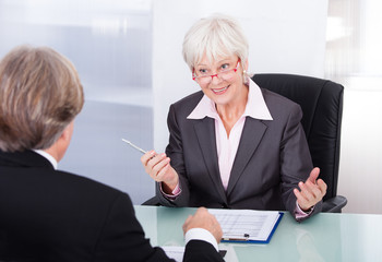 Businessman And Businesswoman In Meeting