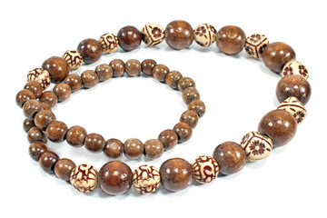 Necklace made of brown wooden balls isolated on white