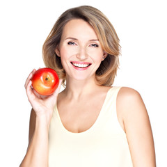 Portrait of a young smiling healthy woman with apple