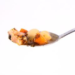 Tablespoon of bean soup on a white background
