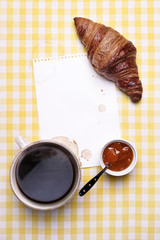 Breakfast scene with Coffee, Croissant, Jam and Blank Paper