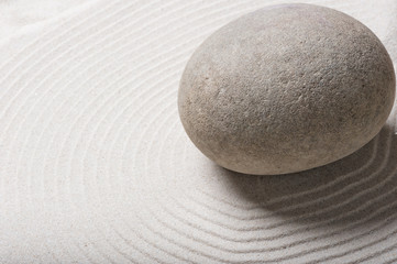 Fototapeta na wymiar big gray smooth stone on sand