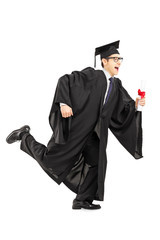 Graduate student running and holding a diploma