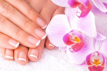 Obraz na płótnie Canvas french manicure with pink orchid on the white