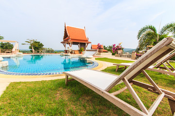 Fototapeta premium Table and chairs beside the pool