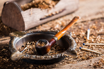 Old pipe in an ashtray