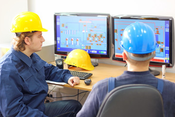 Industrial workers in control room