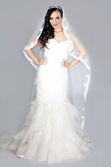 beautiful elegant woman in a white wedding dress posing