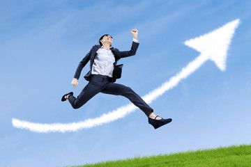 Businesswoman running with arrow up
