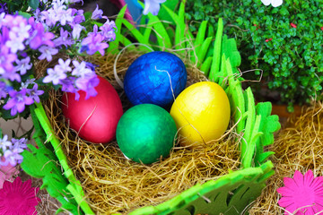 Four easter eggs in a natural straw